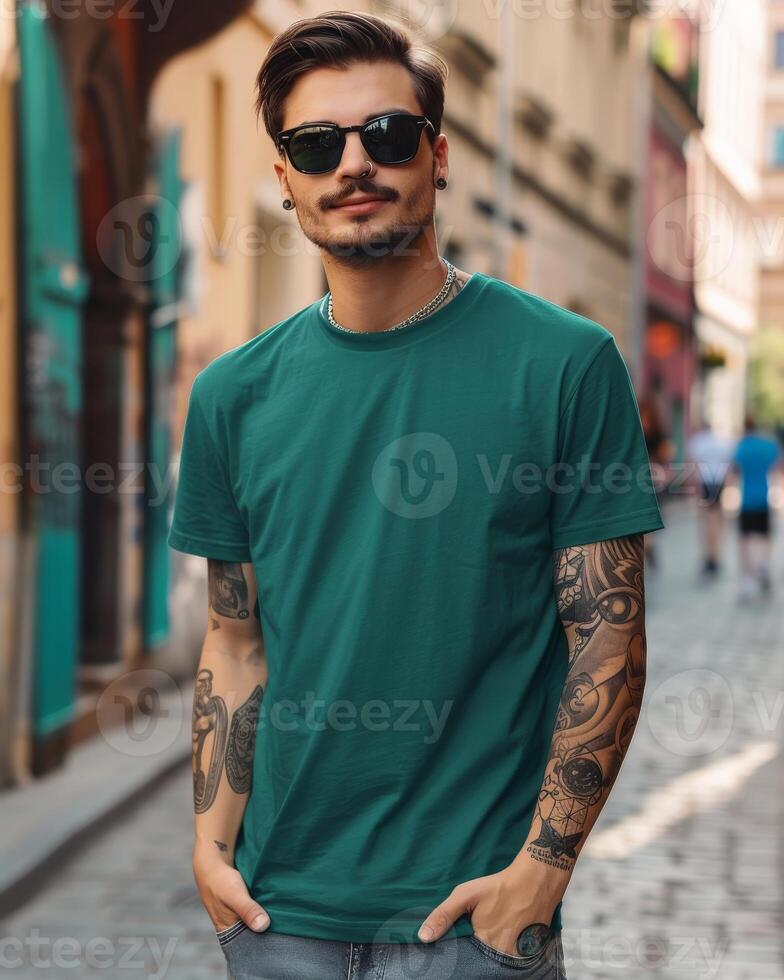 A young man in a green t-shirt walks through a city street photo