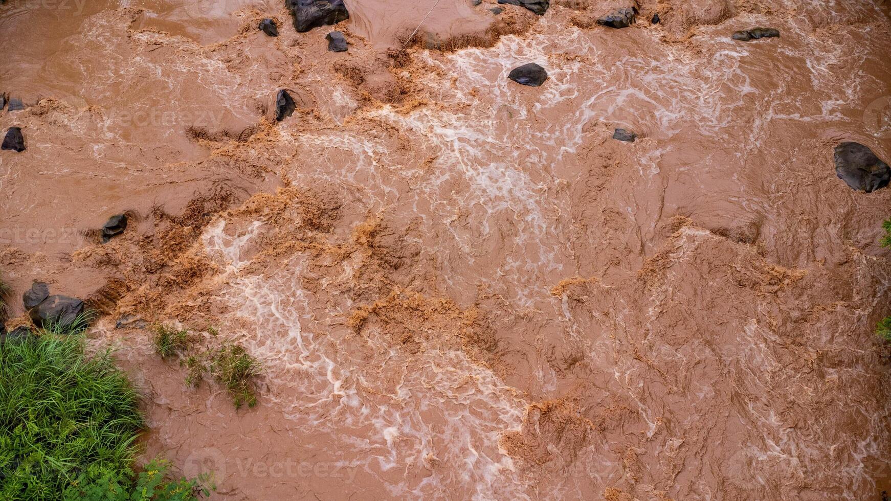 Close-up aerial view of the mighty Mekong River shows its muddy waterways flowing hard and fast during the rainy season. photo