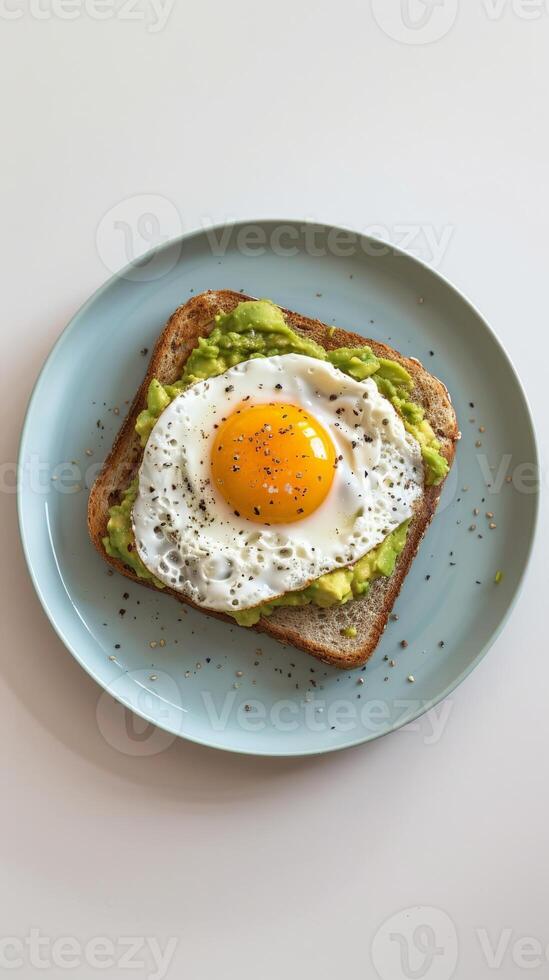 Avocado toast topped with a perfectly poached egg photo