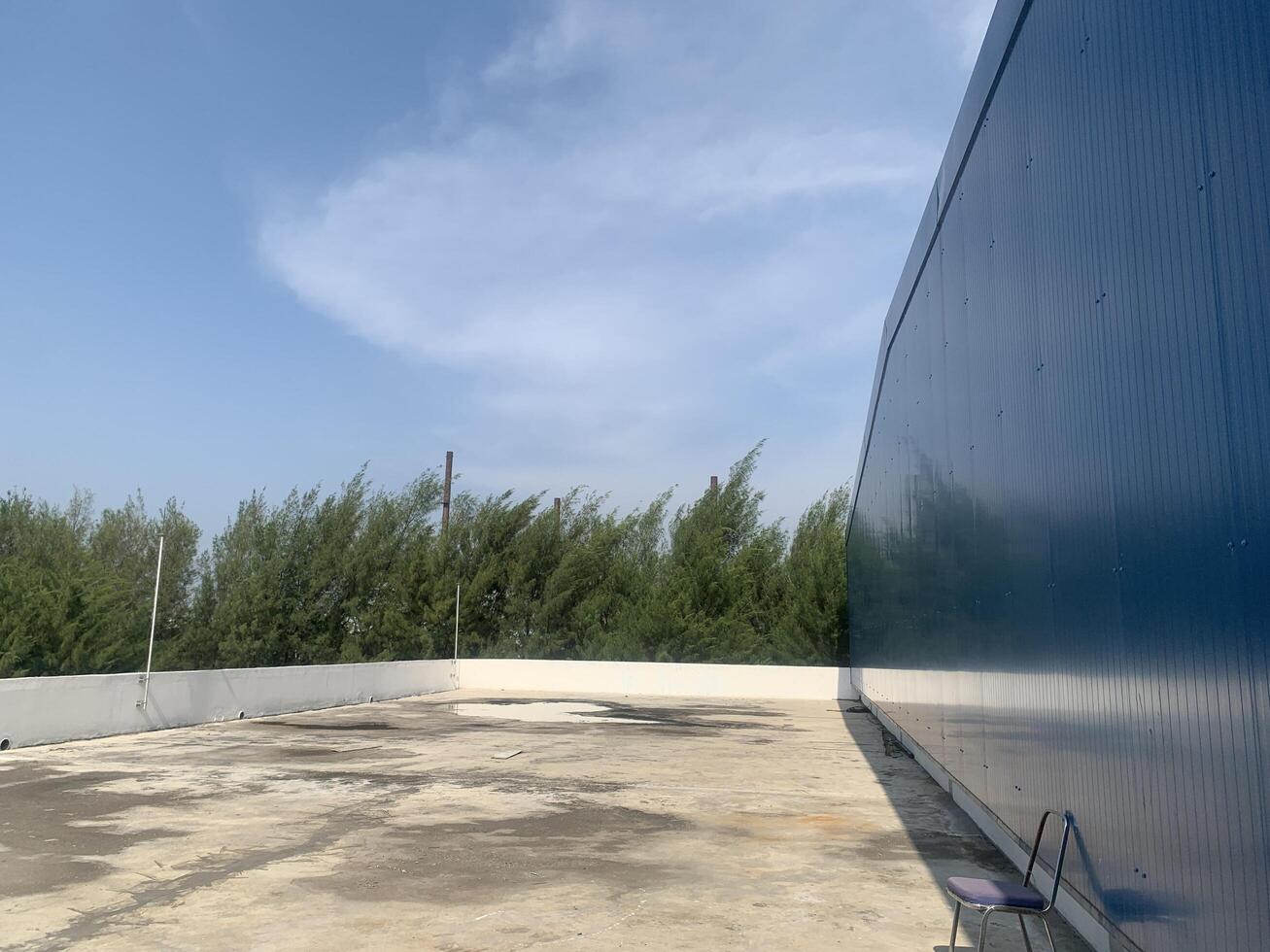 Rooftop View of Building with Blue Wall photo