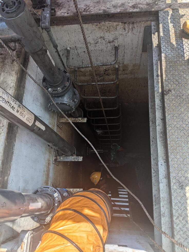Worker in Confined Space with Ventilation Equipment photo