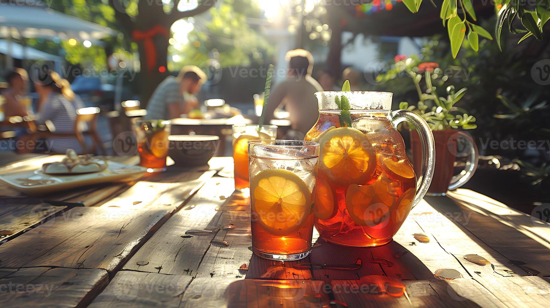 A pitcher of iced tea with lemon slices photo