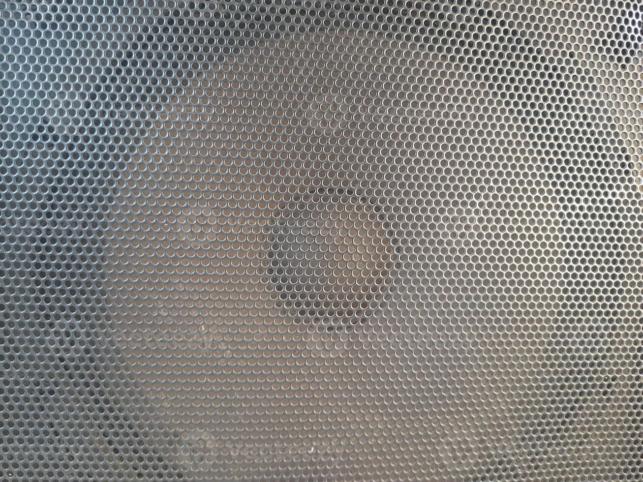 Radio speaker grid texture pattern, rough surface of a radio speaker, texture background, close-up photo