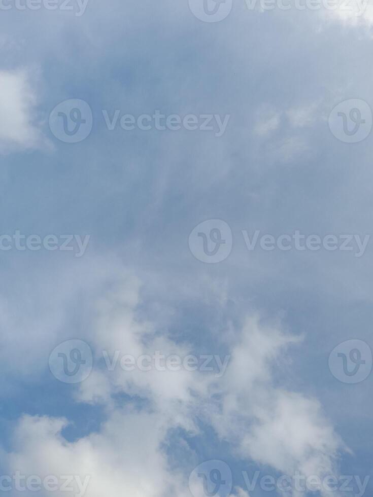 Beautiful white clouds on deep blue sky background. Large bright soft fluffy clouds are cover the entire blue sky. photo