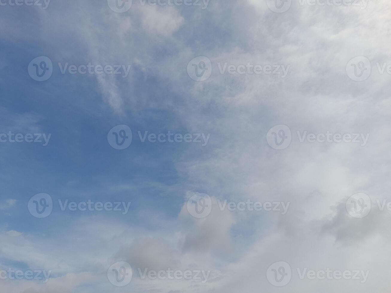 Beautiful white clouds on deep blue sky background. Large bright soft fluffy clouds are cover the entire blue sky. photo
