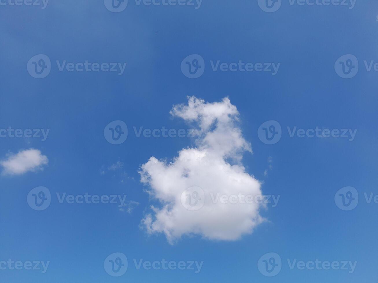 Beautiful white clouds on deep blue sky background. Large bright soft fluffy clouds are cover the entire blue sky. photo