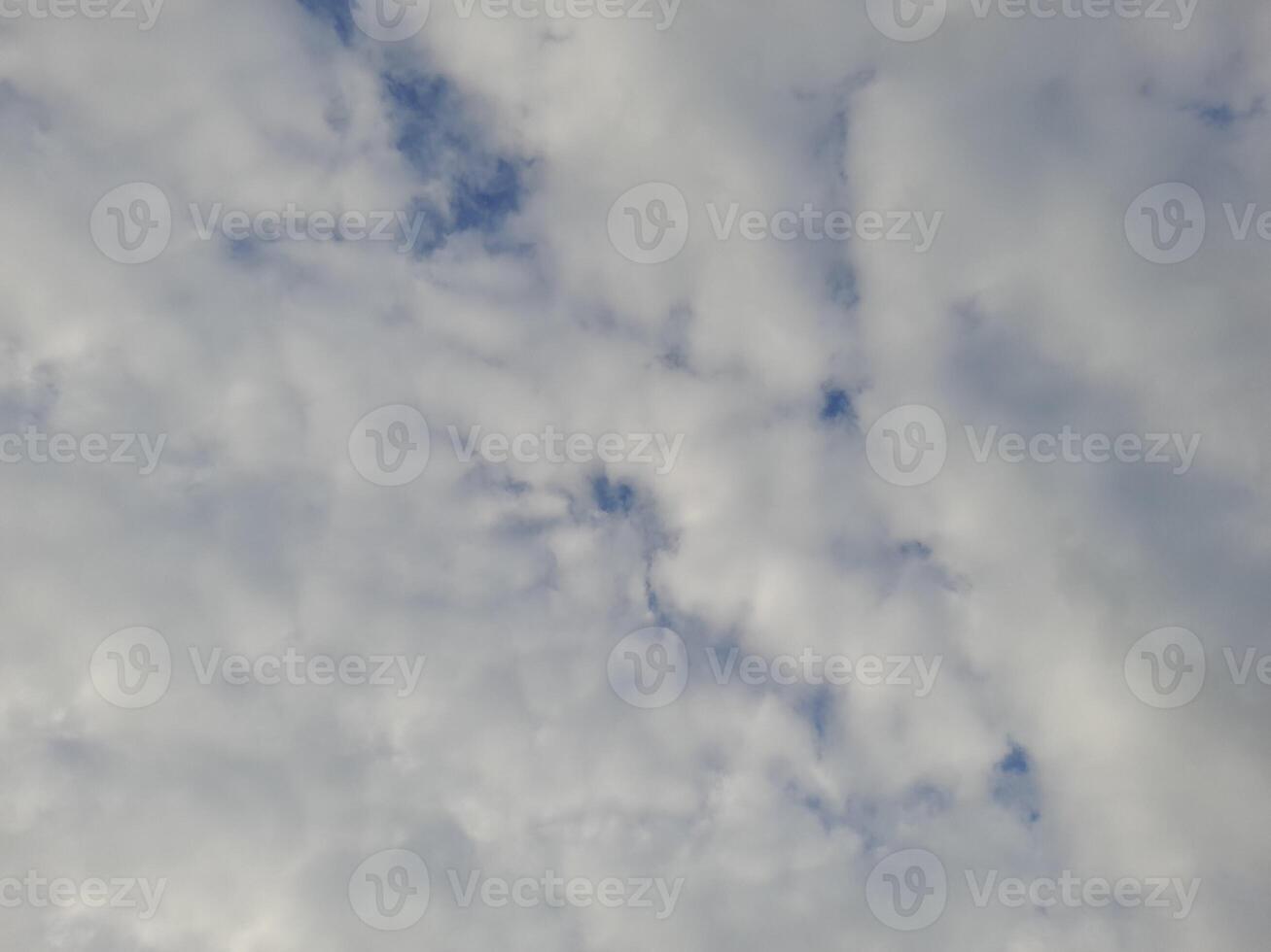 Beautiful white clouds on deep blue sky background. Large bright soft fluffy clouds are cover the entire blue sky. photo