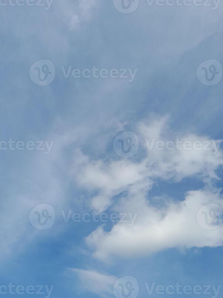 Beautiful white clouds on deep blue sky background. Large bright soft fluffy clouds are cover the entire blue sky. photo