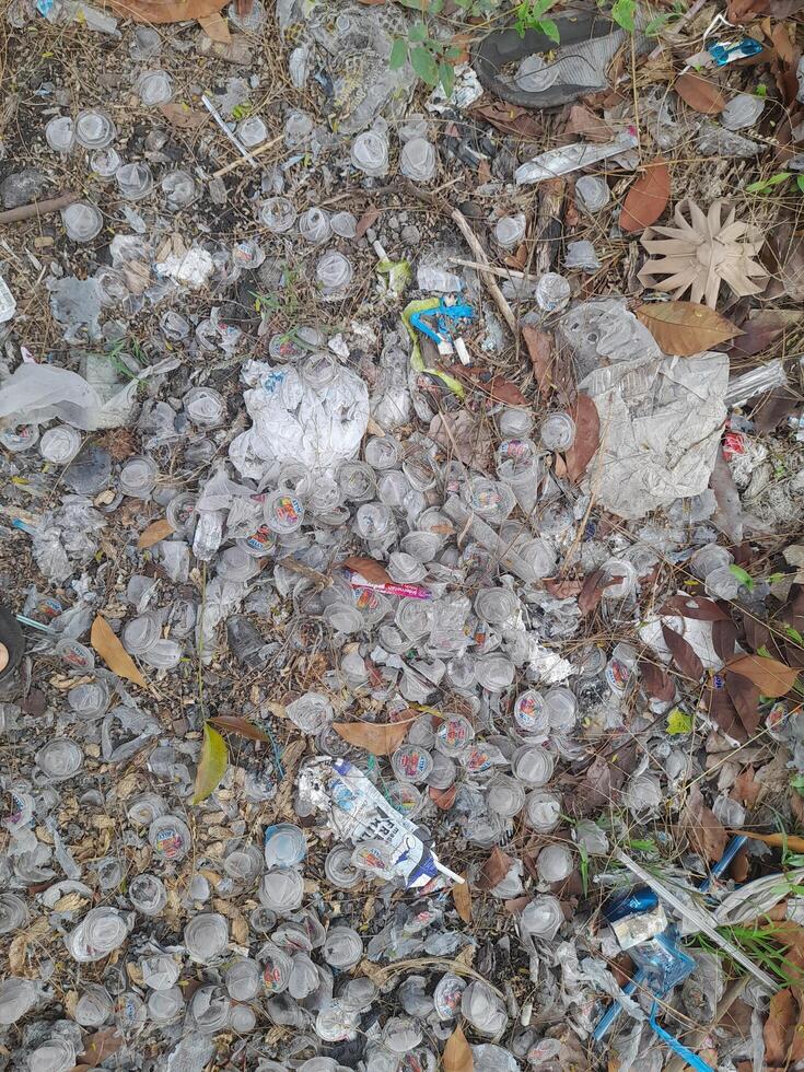 Lombok Island, Indonesia - July 7, 2024 - Plastic waste that is widely scattered on the ground photo