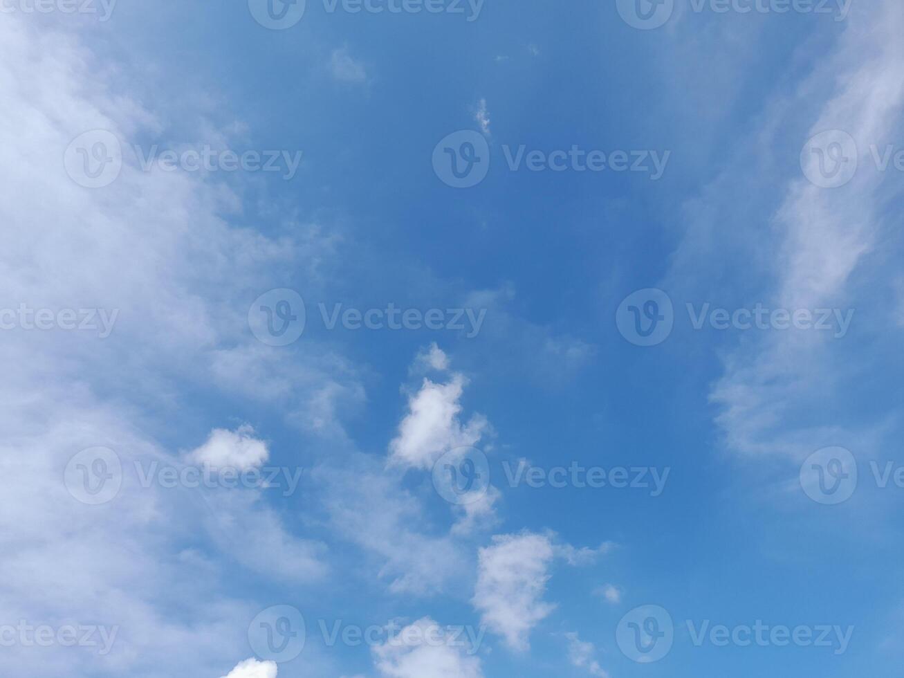 Beautiful white clouds on deep blue sky background. Large bright soft fluffy clouds are cover the entire blue sky. photo