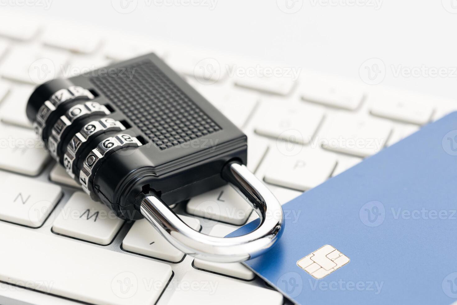 Padlock and credit card on computer keyboard. E-commerce internet and finance security concept photo