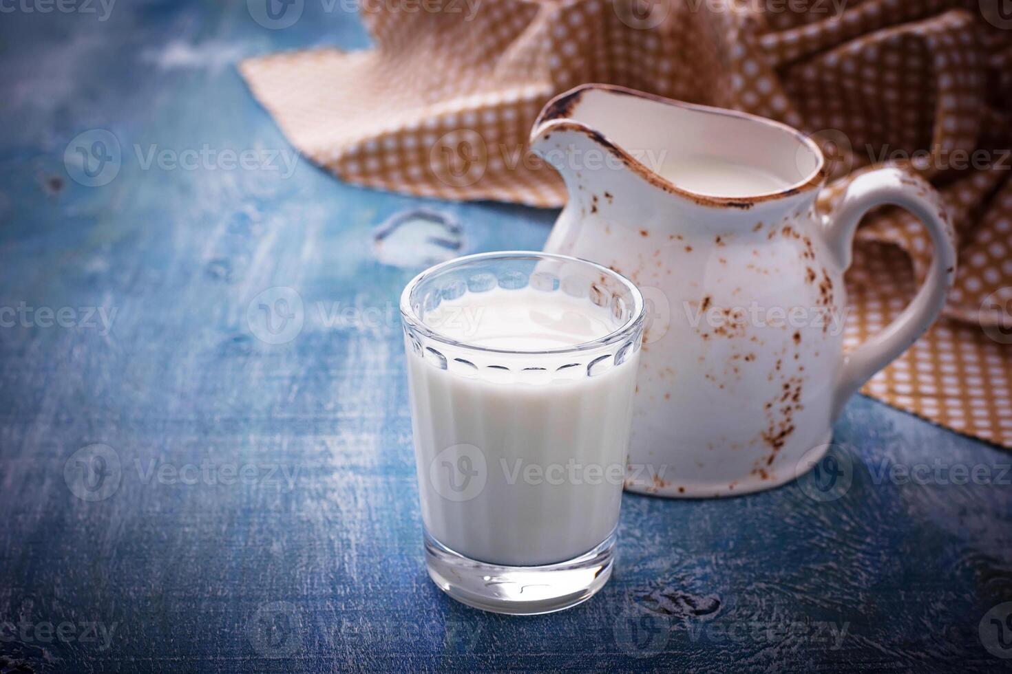 Glass of milk and jug. photo