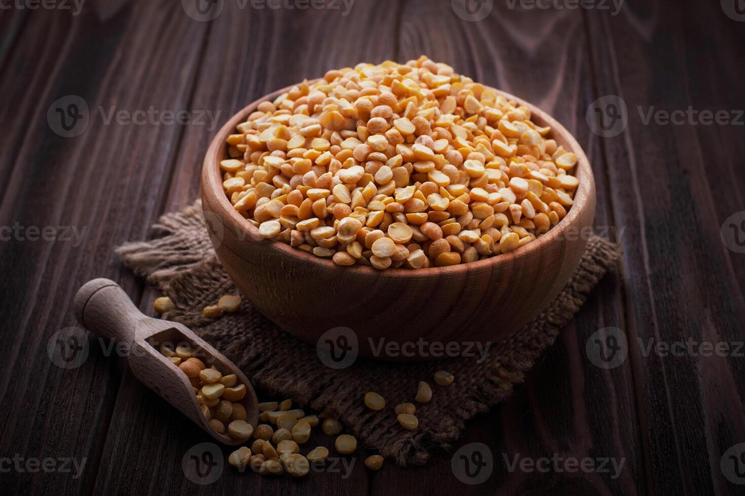 Yellow dry peas in wooden bowl photo