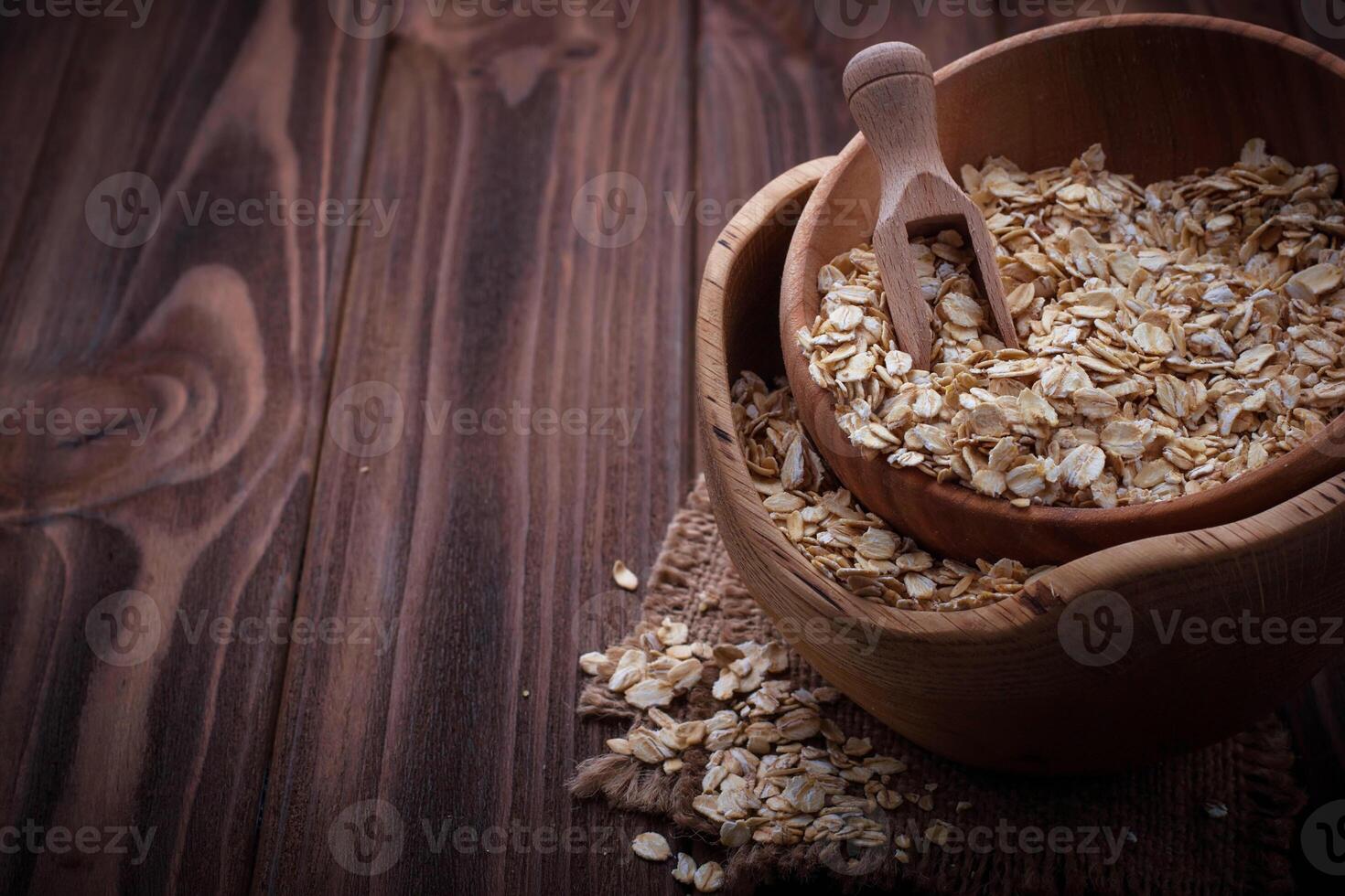 Oat flakes in wooden bowl photo