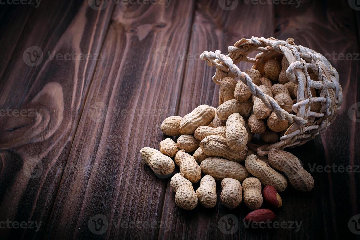 Peanuts in shell on wooden background photo