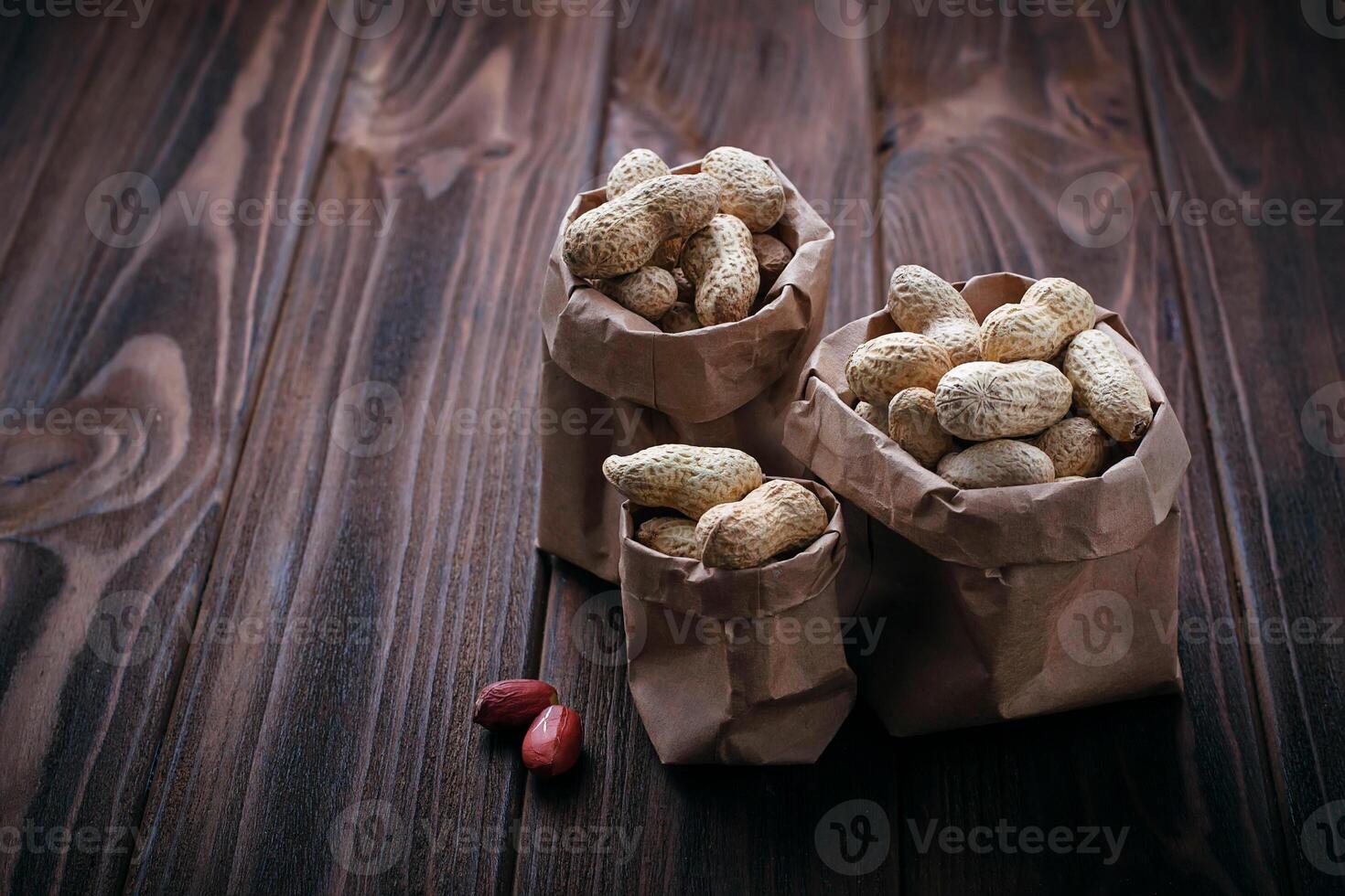 Peanuts in shell on wooden background photo