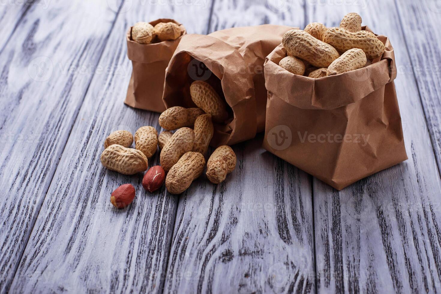 Peanuts in shell on wooden background photo