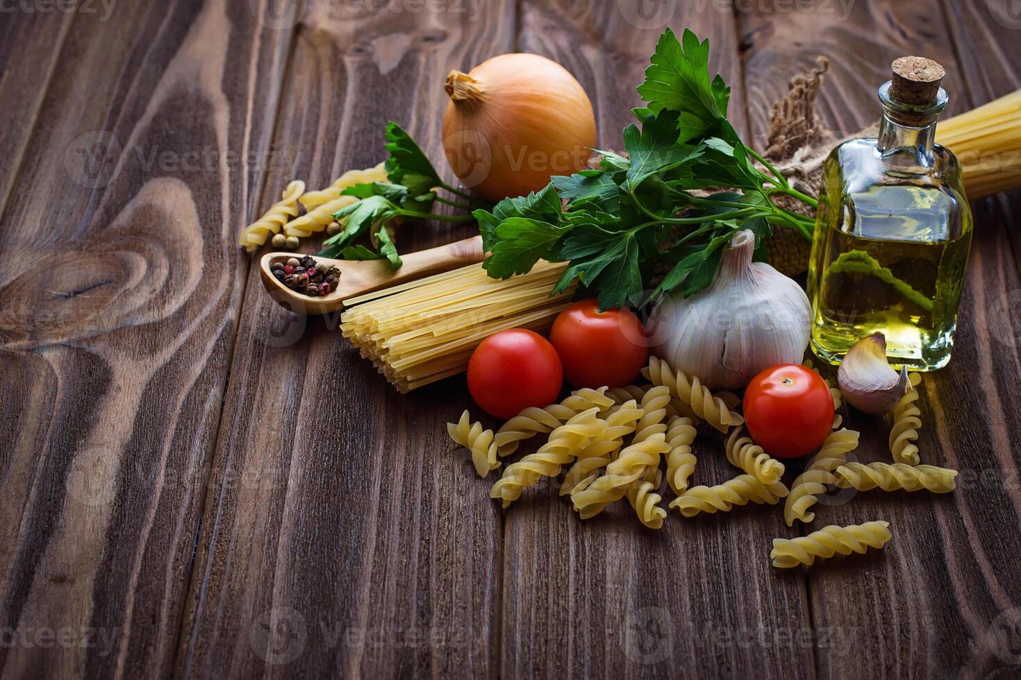 Tomato, uncooked pasta, garlic, parsley photo