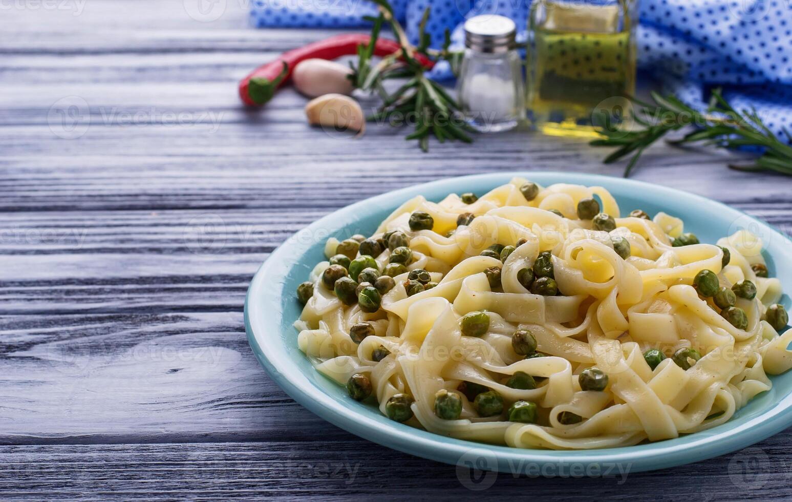 Pasta tagliatelle with green peas photo