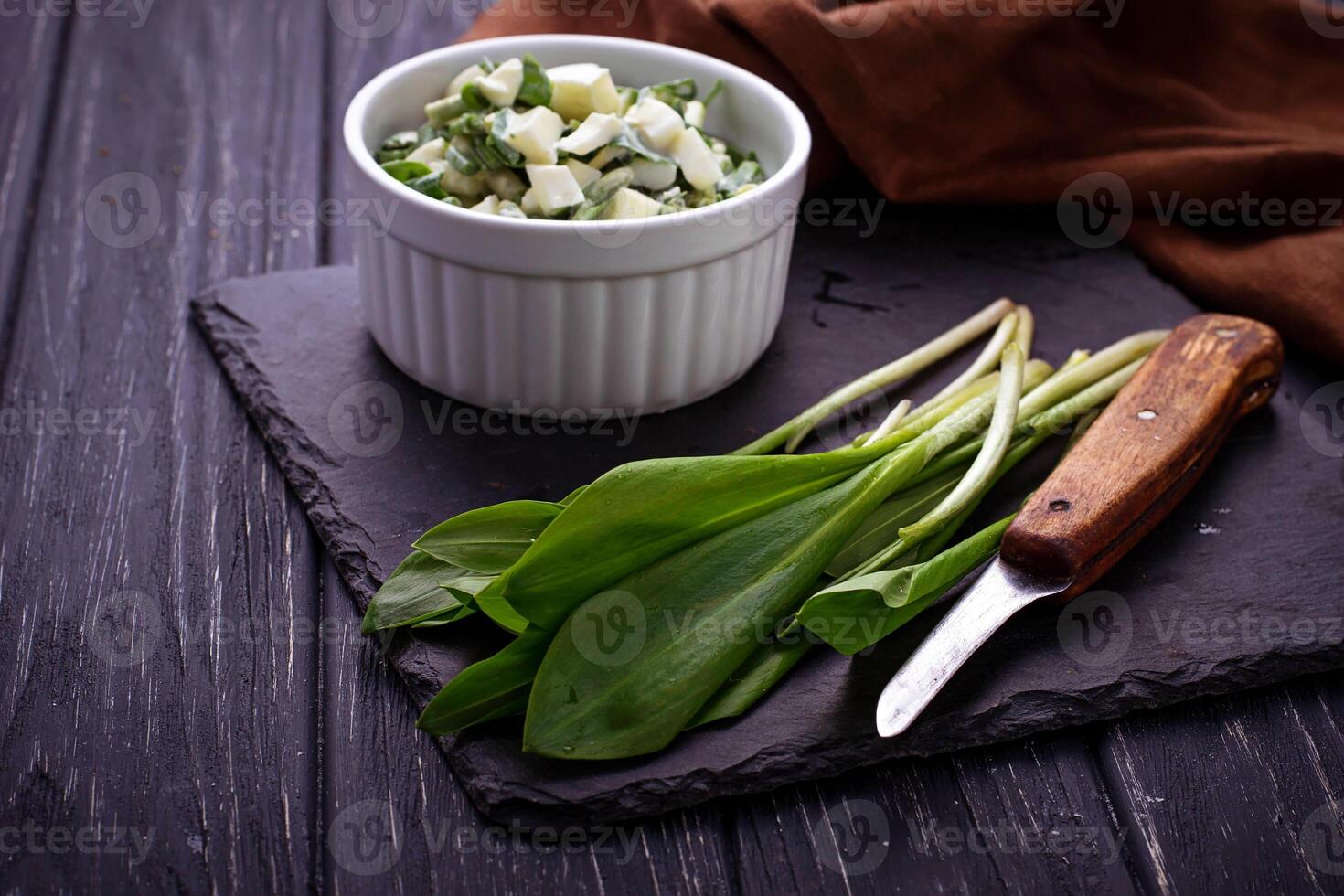 Ramson and knife on slate background photo