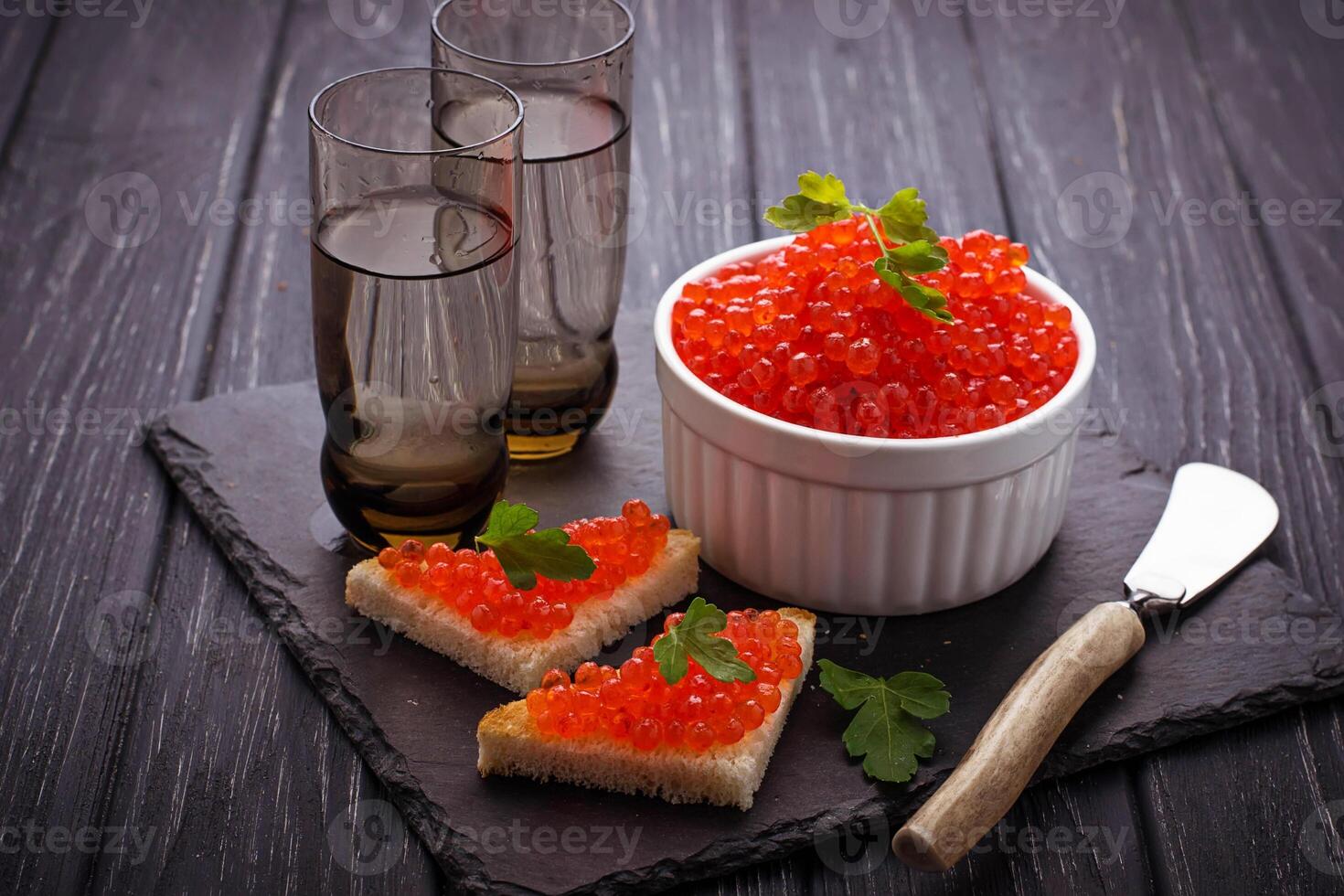 Red caviar on slate background photo