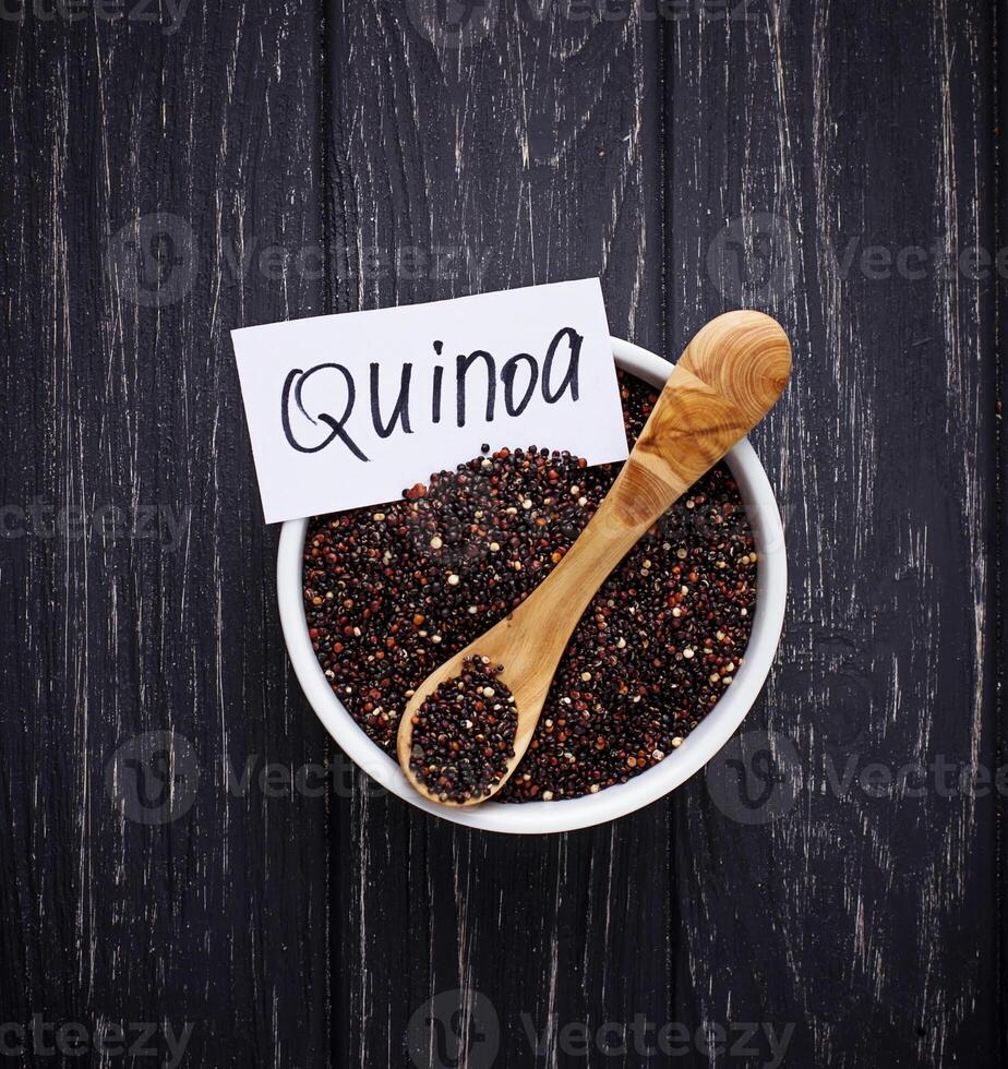 Uncooked black quinoa in bowl photo