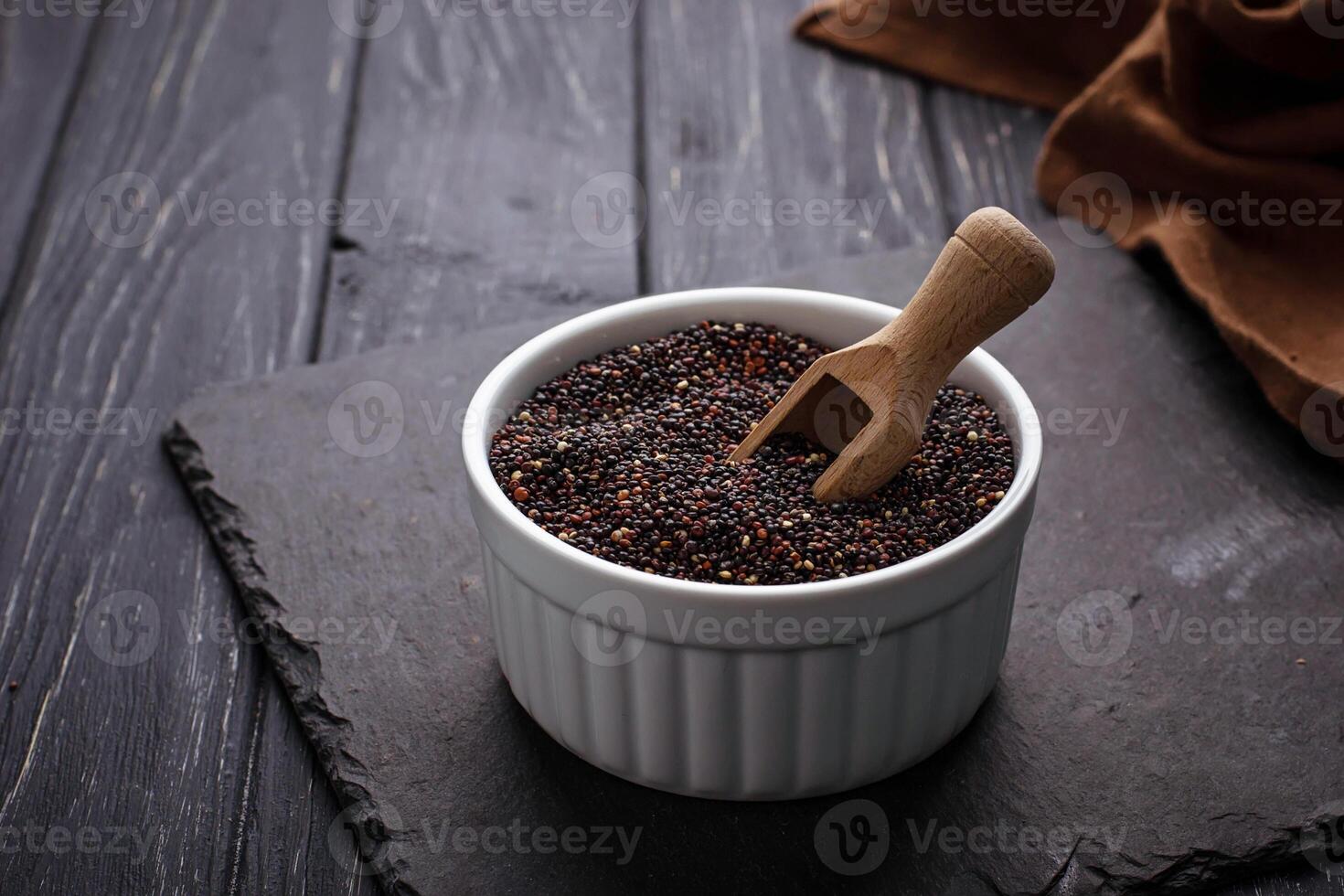 Uncooked black quinoa in bowl photo