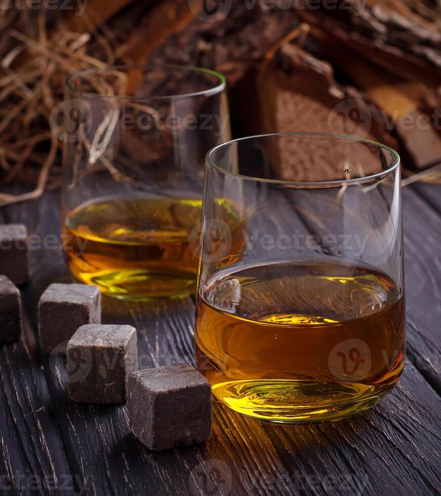 Glass of whiskey with stones photo
