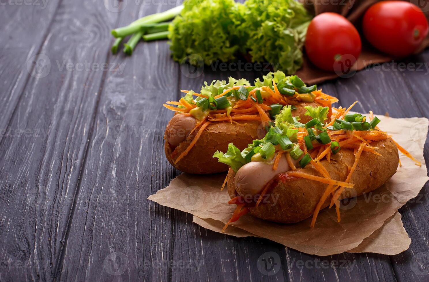 Hot dog with sausage, carrot, onion, lettuce photo