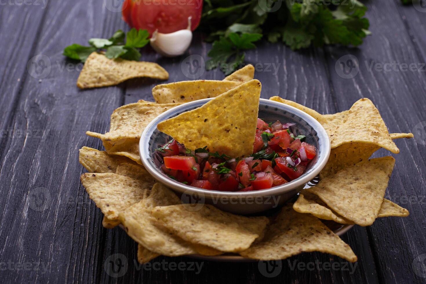 Mexican corn chips nachos with salsa dip photo