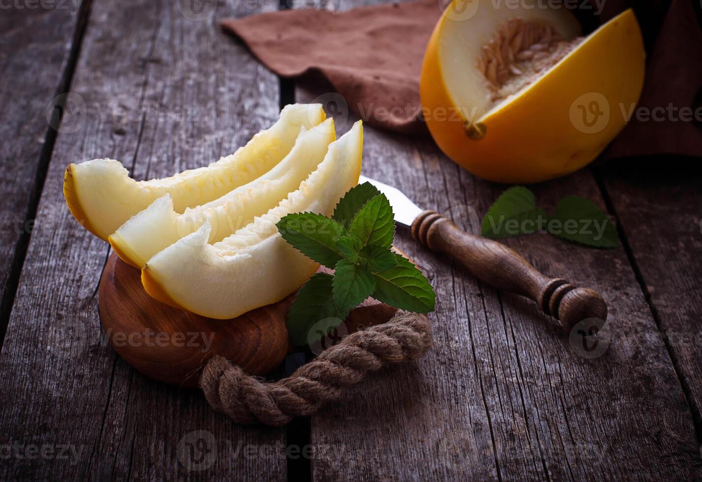 Fresh sweet sliced melon with mint photo