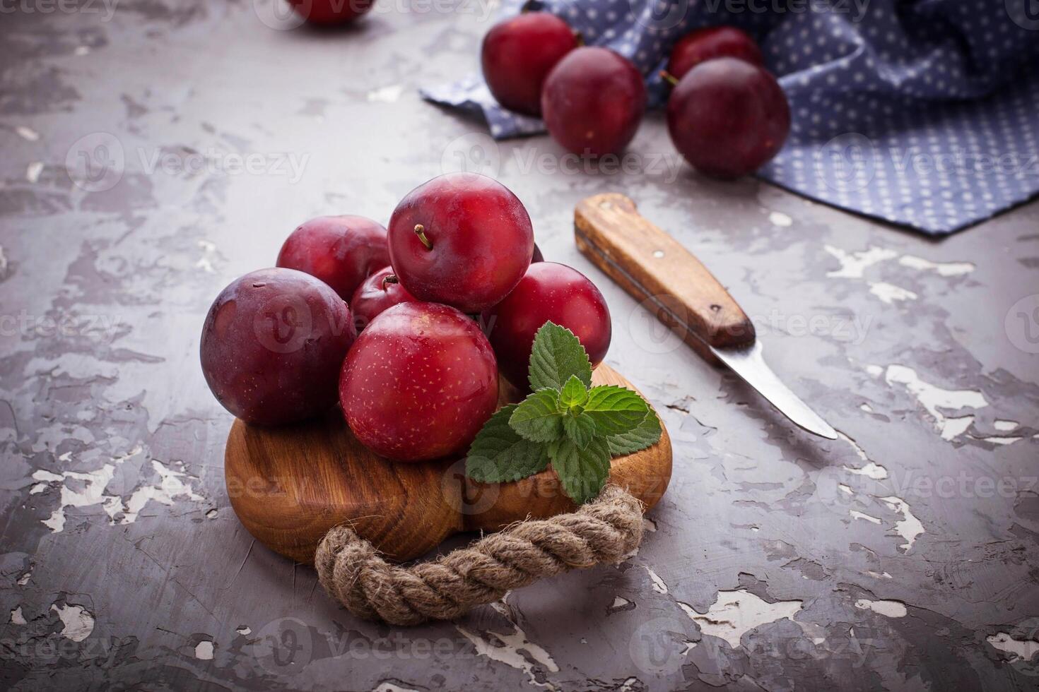 Sweet plums on wooden background photo