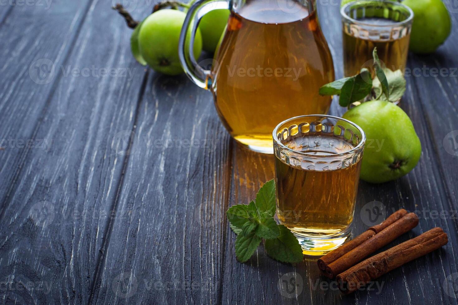 Glasses with apple juice on wooden table photo