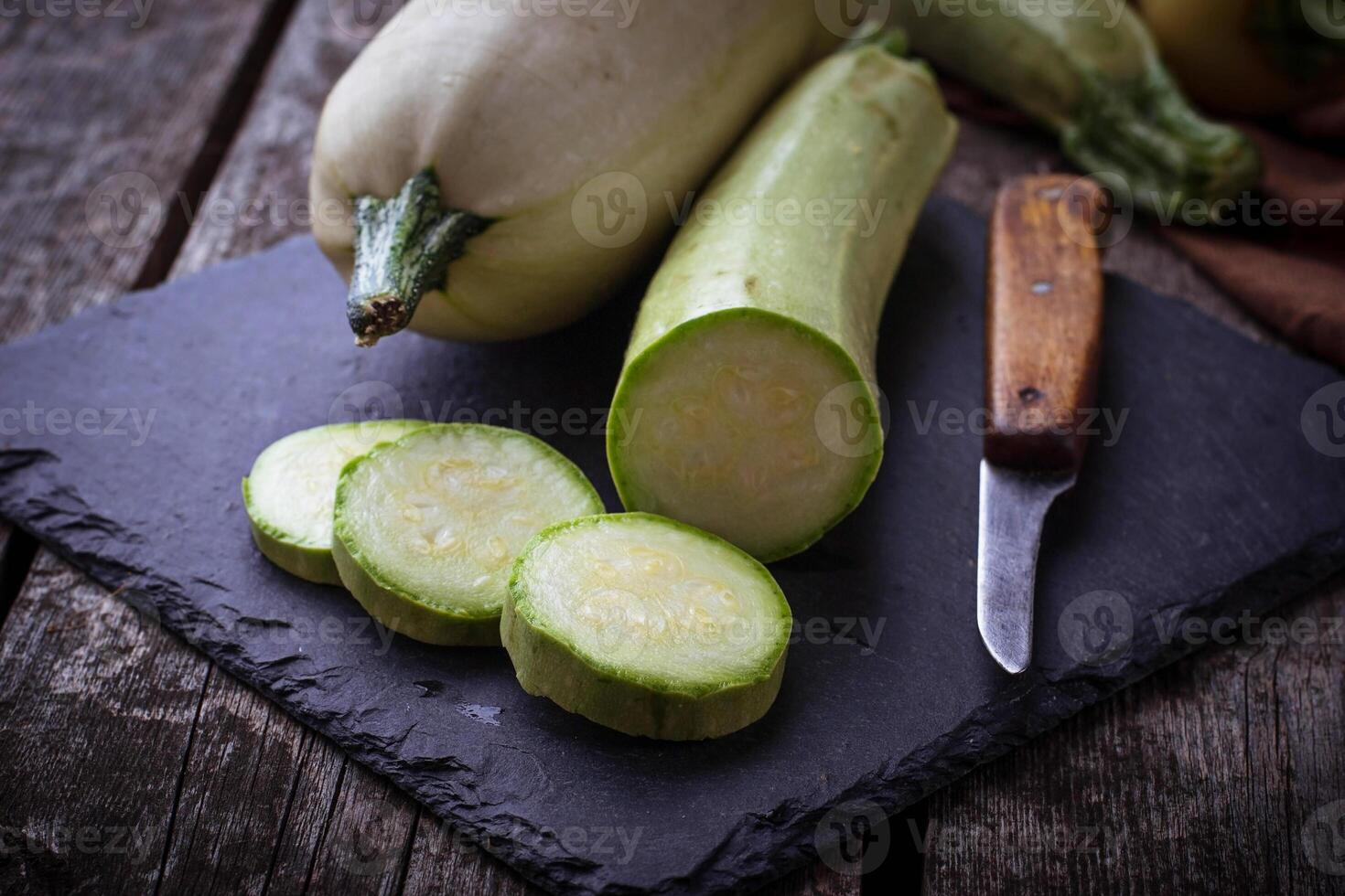 Fresh zucchini on wooden background photo