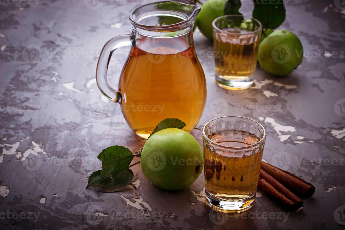 Glasses with apple juice on wooden table photo