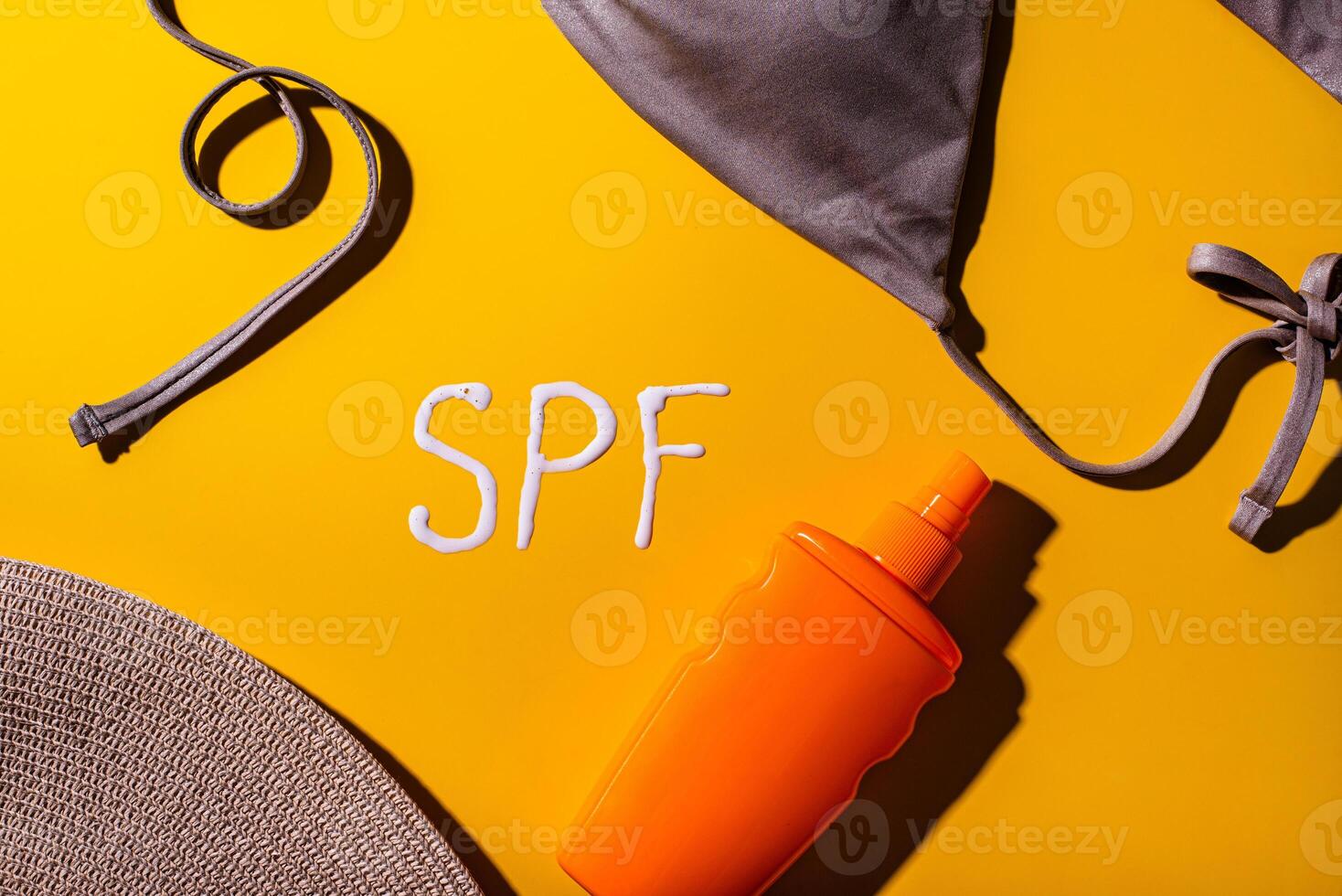 Sunscreen SPF cream on yellow background photo