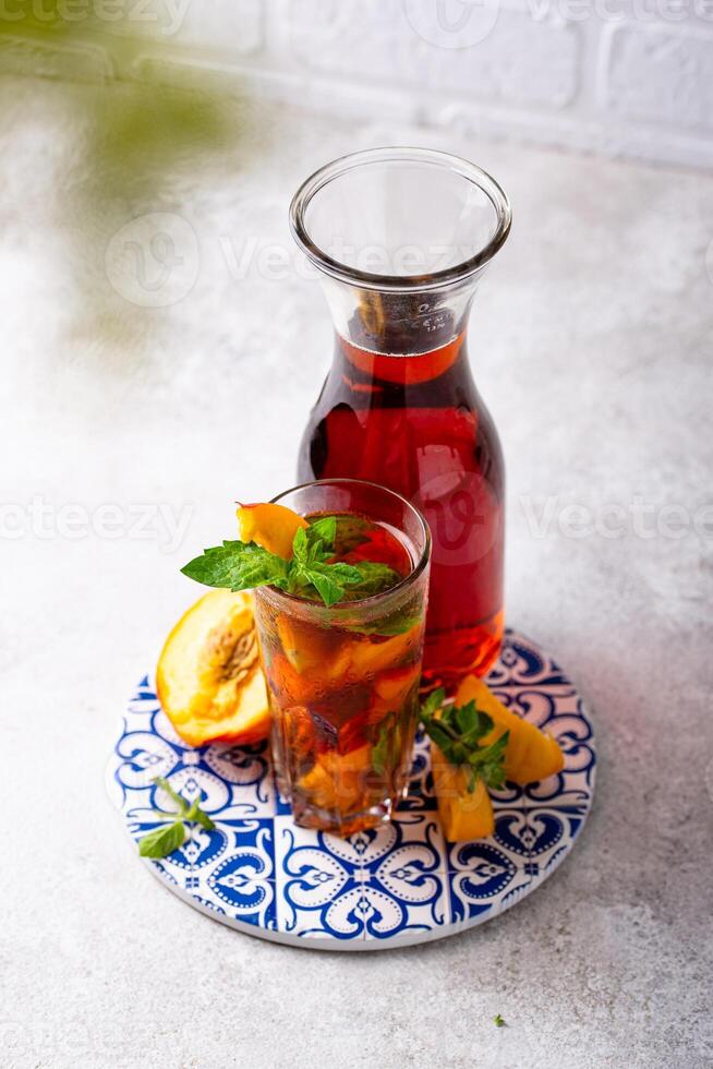 Cold ice tea with peach and mint photo