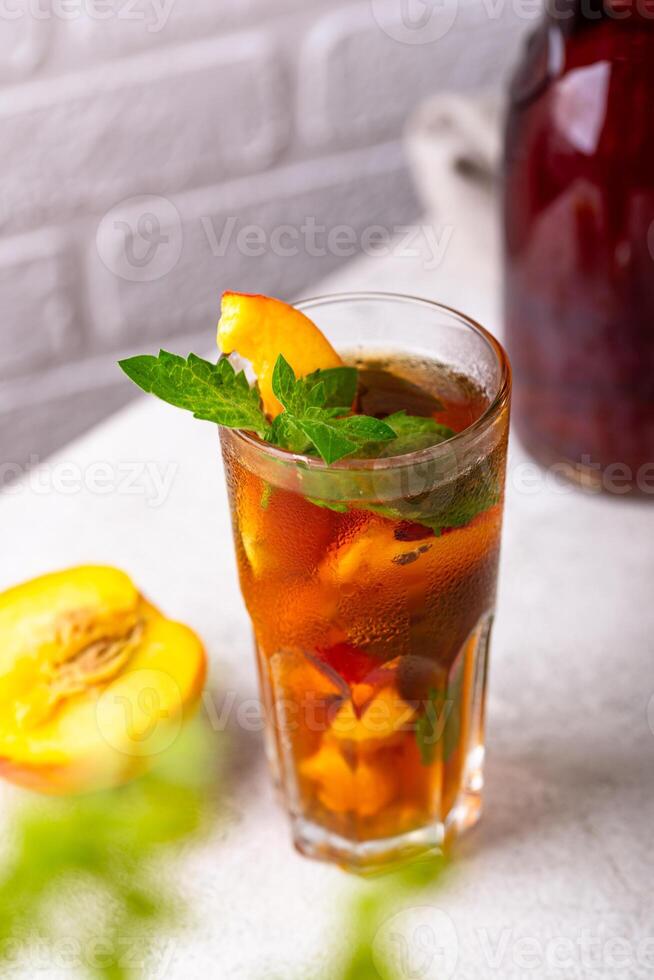 Cold ice tea with peach and mint photo