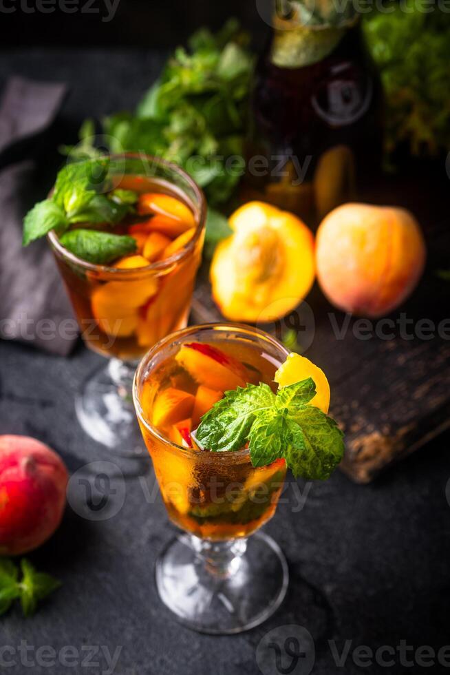 Cold ice tea with peach and mint photo