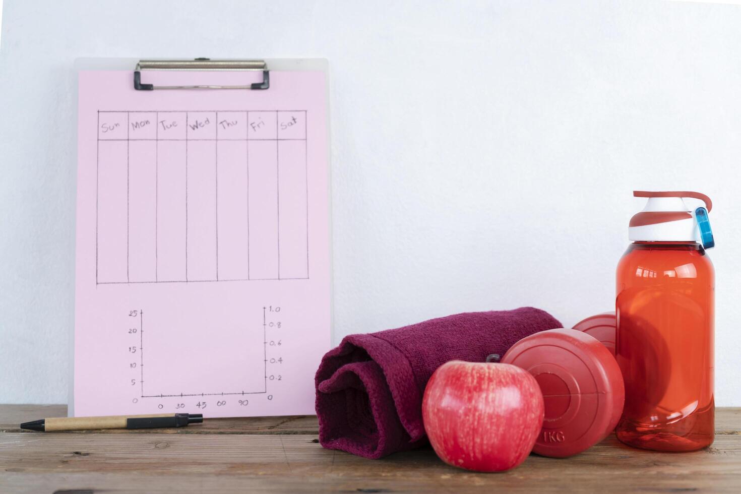 Personal workout plan with towels and other exercise equipment. photo