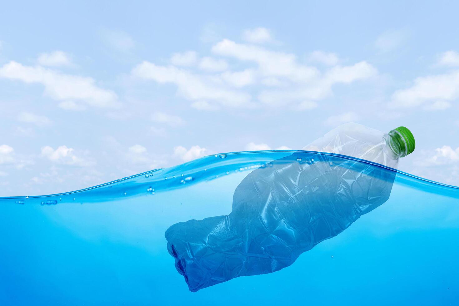 plastic waste at the ocean, a plastic bottle floating in the Mediterranean sea at the water surface photo