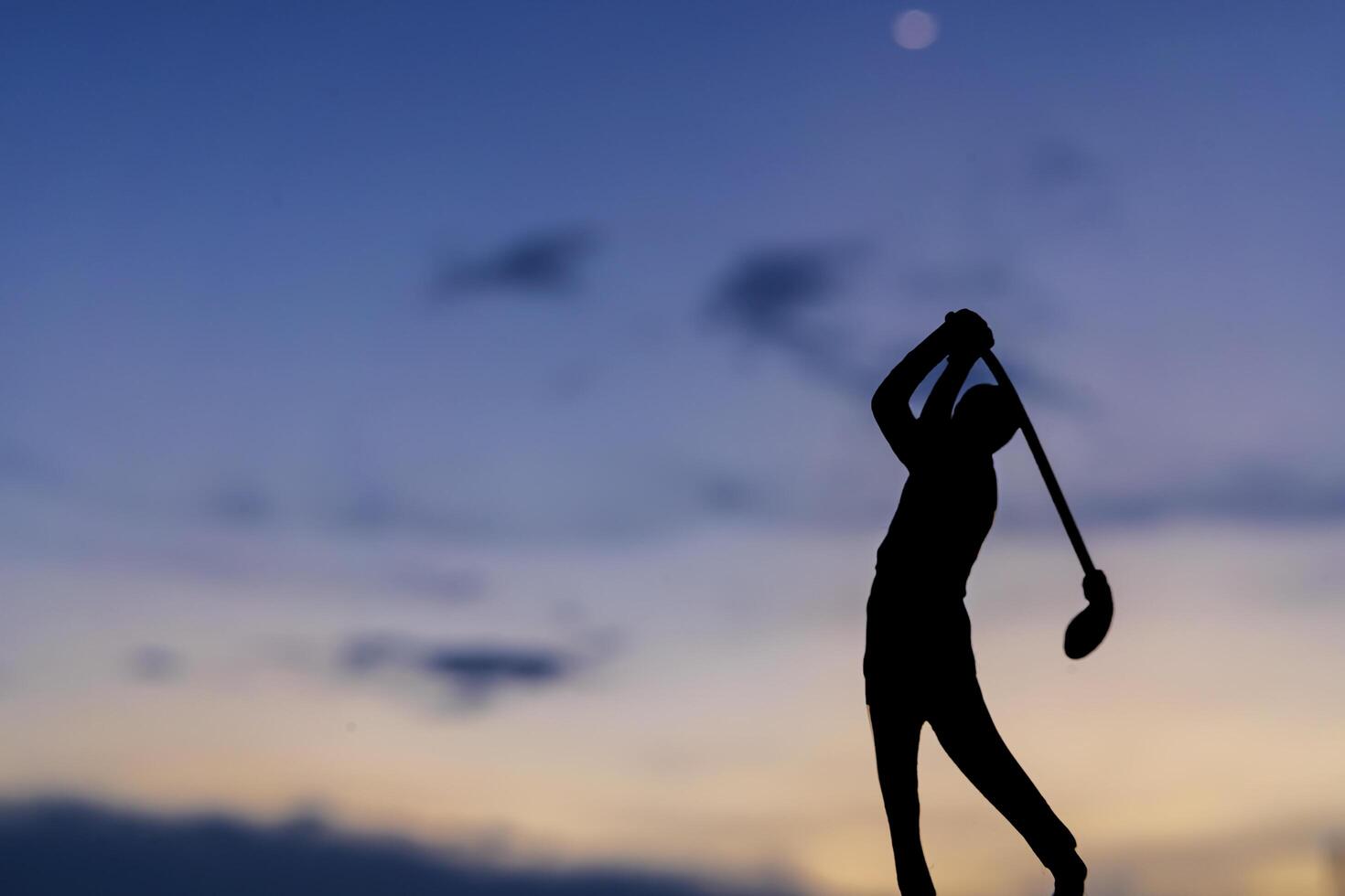 silhouette of golfers hit sweeping and keep golf course in the summer photo