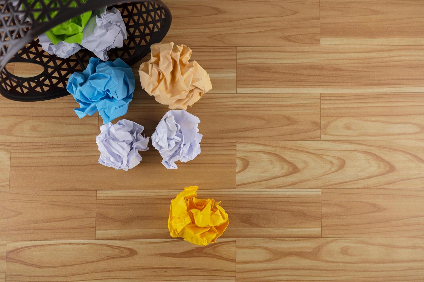 Crumpled paper balls. A trash can with a piece of paper photo