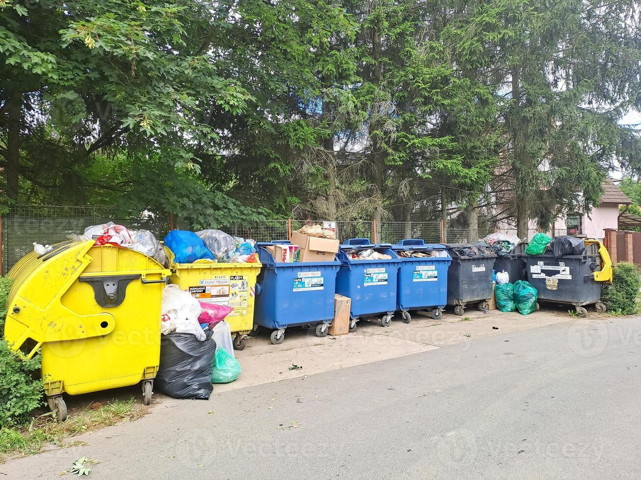Dumpsters being full with garbage. Trash can overflowing litter pollution photo