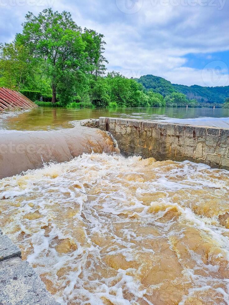 The river Berunka swollen after heavy rainfall and flood water crashing valley photo