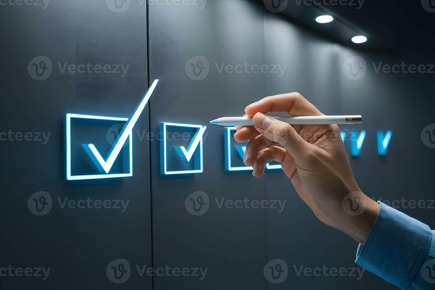 Hand holding stylus against dark gray background with illuminated blue checkmarks photo