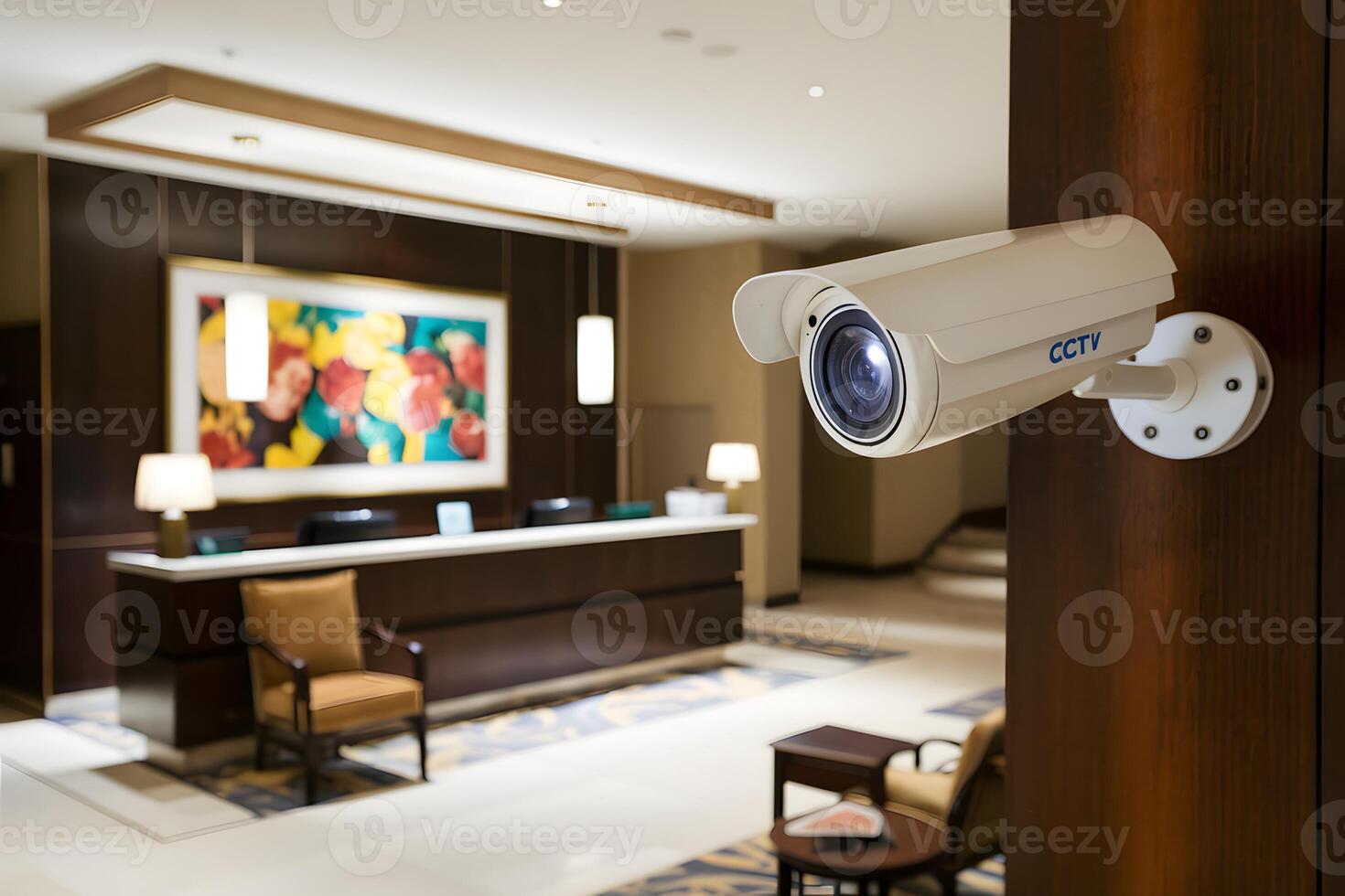 Well lit hotel lobby with CCTV camera, reception desk visible photo