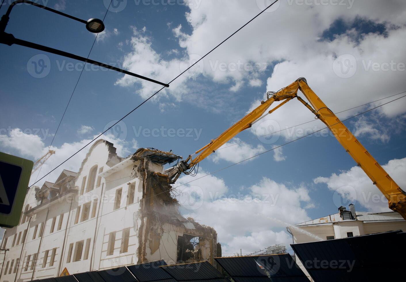 Excavator for demolition of buildings with a hydraulic crusher. The concept of demolition of buildings using excavators. photo