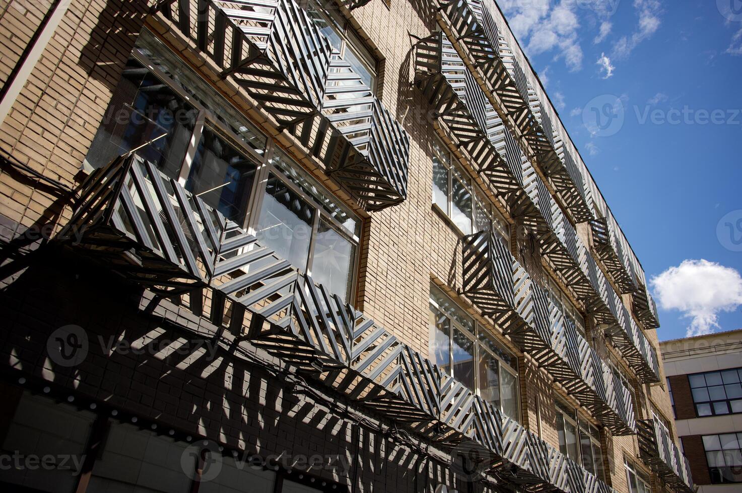 View of the facade of a black and white building with balconies. City. The steel facade of a residential building in the city. photo