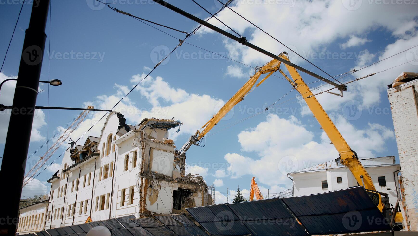 Excavator for demolition of buildings with a hydraulic crusher. The concept of demolition of buildings using excavators. photo